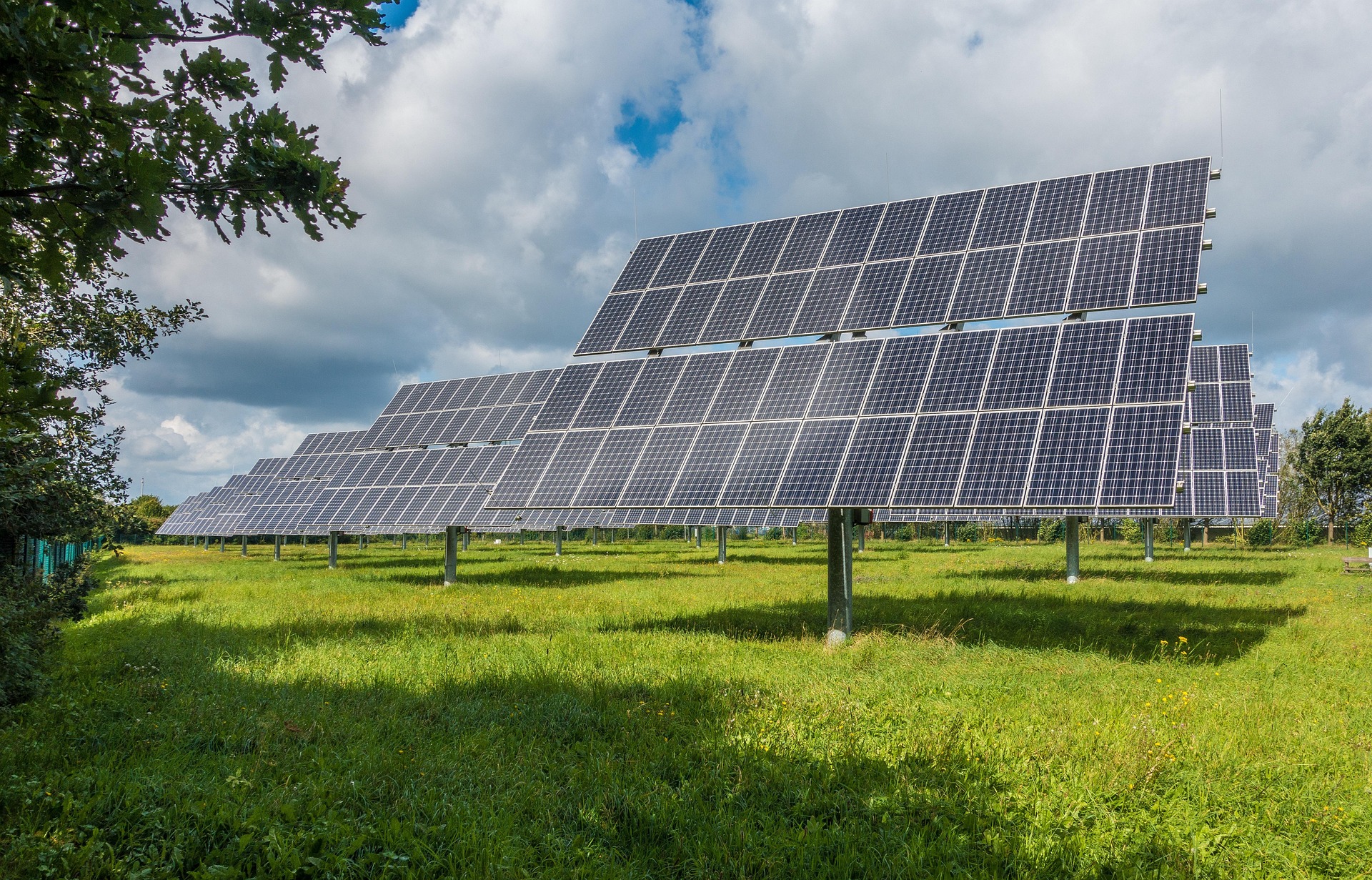 Solar panels in green field, renewable energy technology